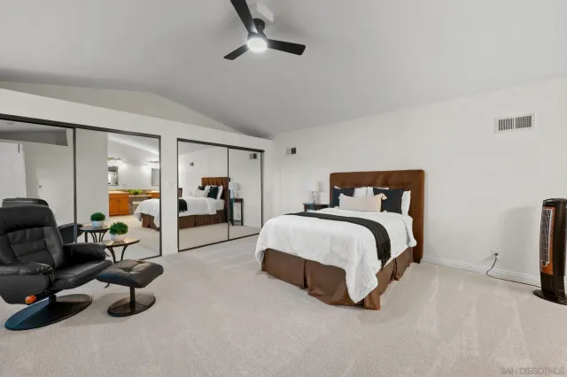 a bedroom with bed and a tv