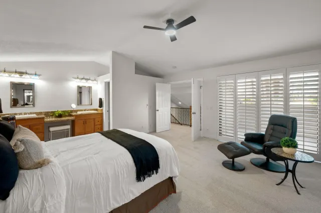 a bedroom with a bed a couch and dresser