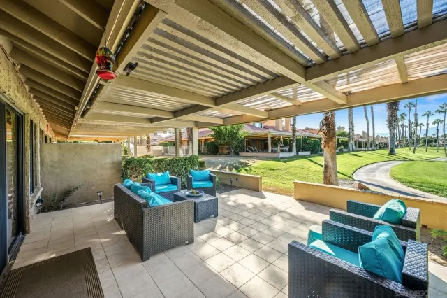a view of a porch with furniture and garden