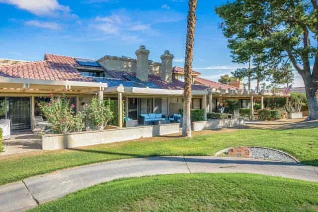 a view of a house with a swimming pool and a yard