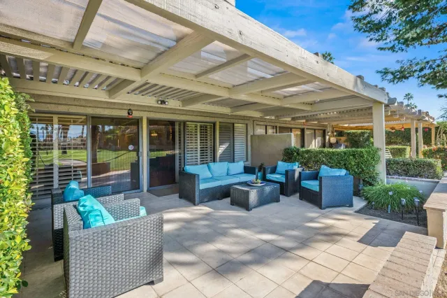 a view of a patio with couches chairs and potted plants