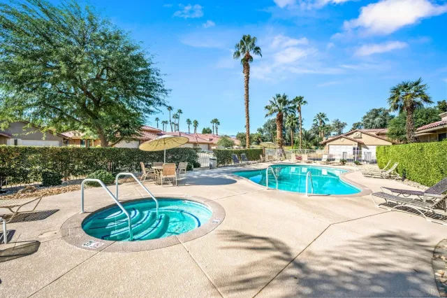 a view of a swimming pool with a chair and tables