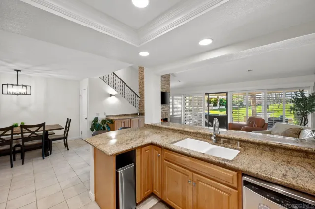 a kitchen with granite countertop a sink and a counter top space