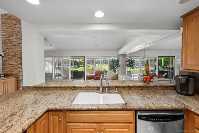 a kitchen with sink and view living room