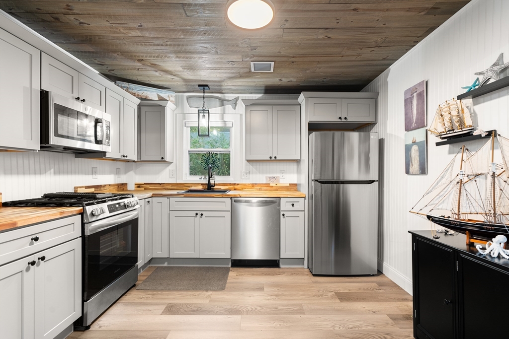 25 Lakeview Drive Wareham, MA 02538 - Photo 16 of 31 a kitchen with stainless steel appliances granite countertop a refrigerator a stove and a sink