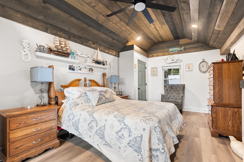 25 Lakeview Drive Wareham, MA 02538 - Photo 17 of 31 a bedroom with a bed and a refrigerator