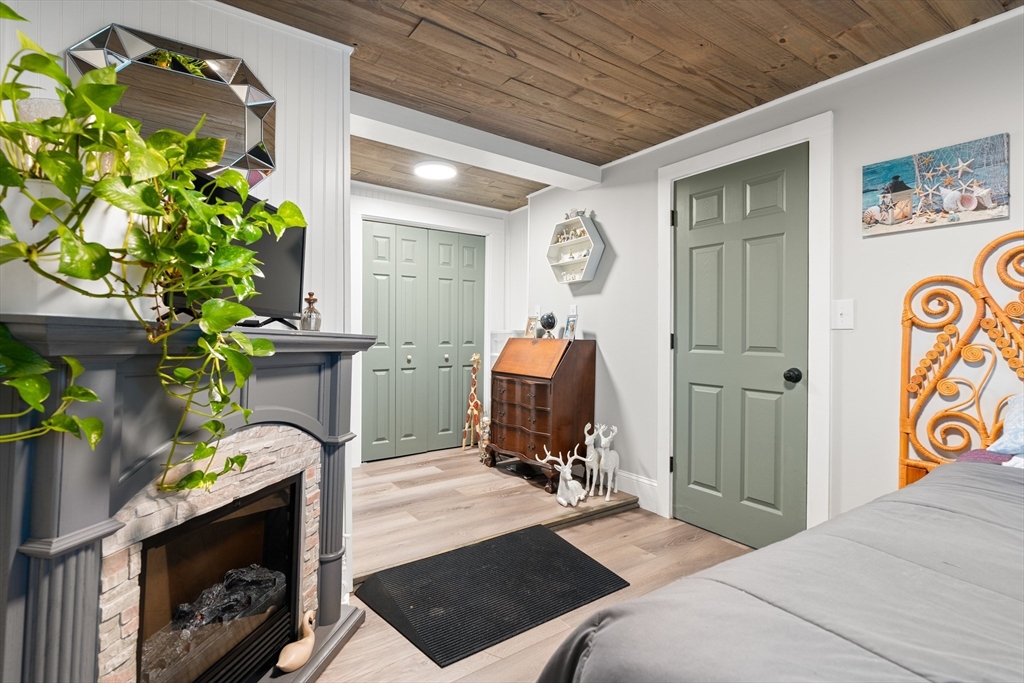 25 Lakeview Drive Wareham, MA 02538 - Photo 22 of 31 a bedroom with a bed table and a potted plant