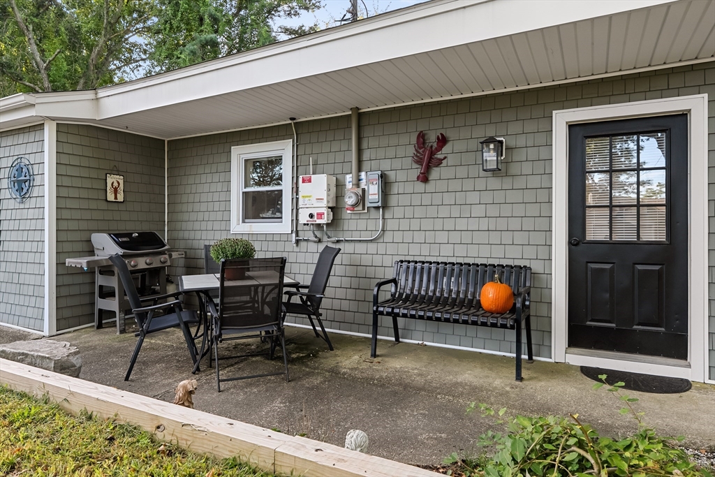 25 Lakeview Drive Wareham, MA 02538 - Photo 4 of 31 a backyard of a house with chairs and a table