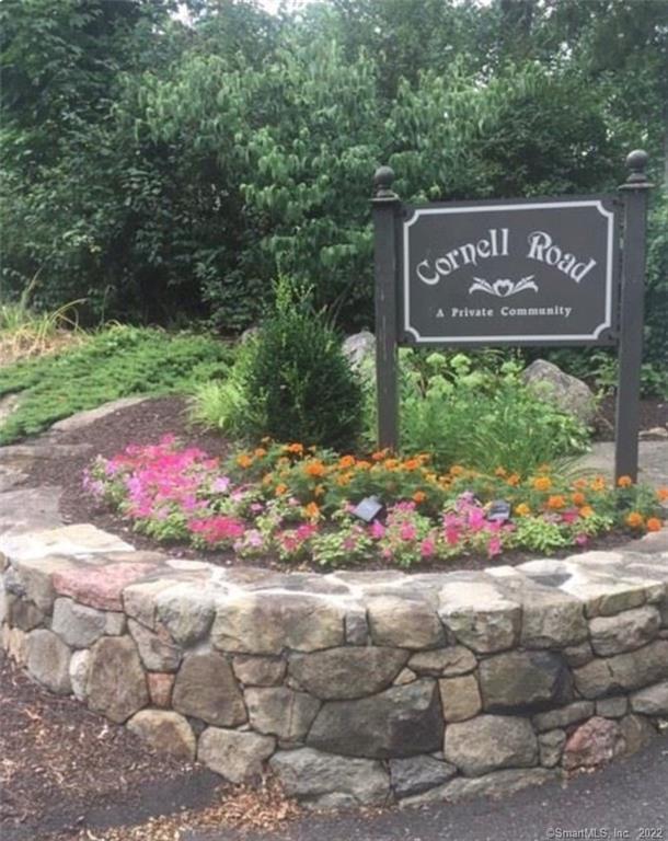 25 Cornell Road Danbury, CT 06811 - Photo 1 of 1 a sign that is in front of flowers