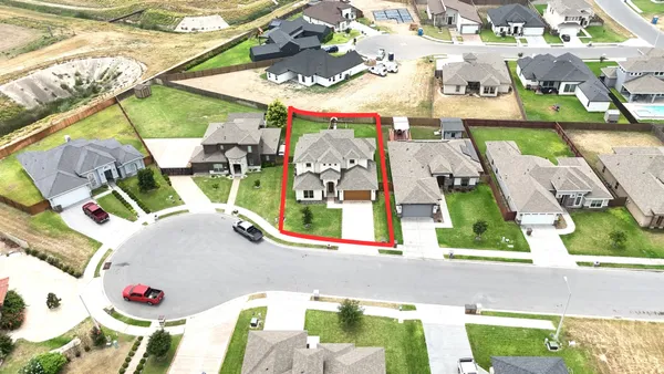 an aerial view of a house a swimming pool and outdoor space