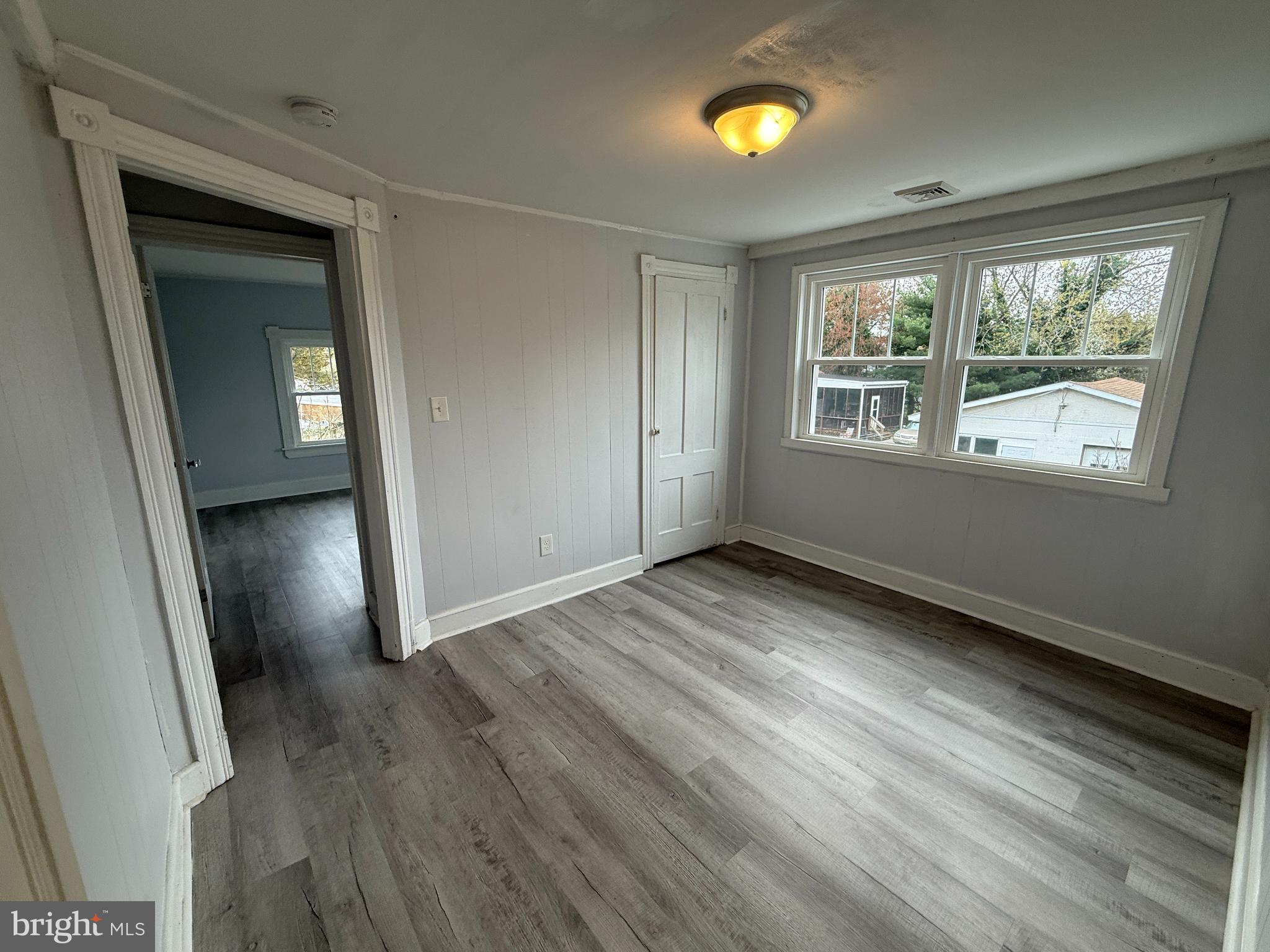 1036 South Spring Road Vineland, NJ 08361 - Photo 29 of 31 an empty room with wooden floor and windows