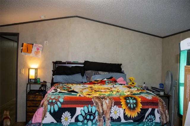 a bedroom with a bed and a potted plant