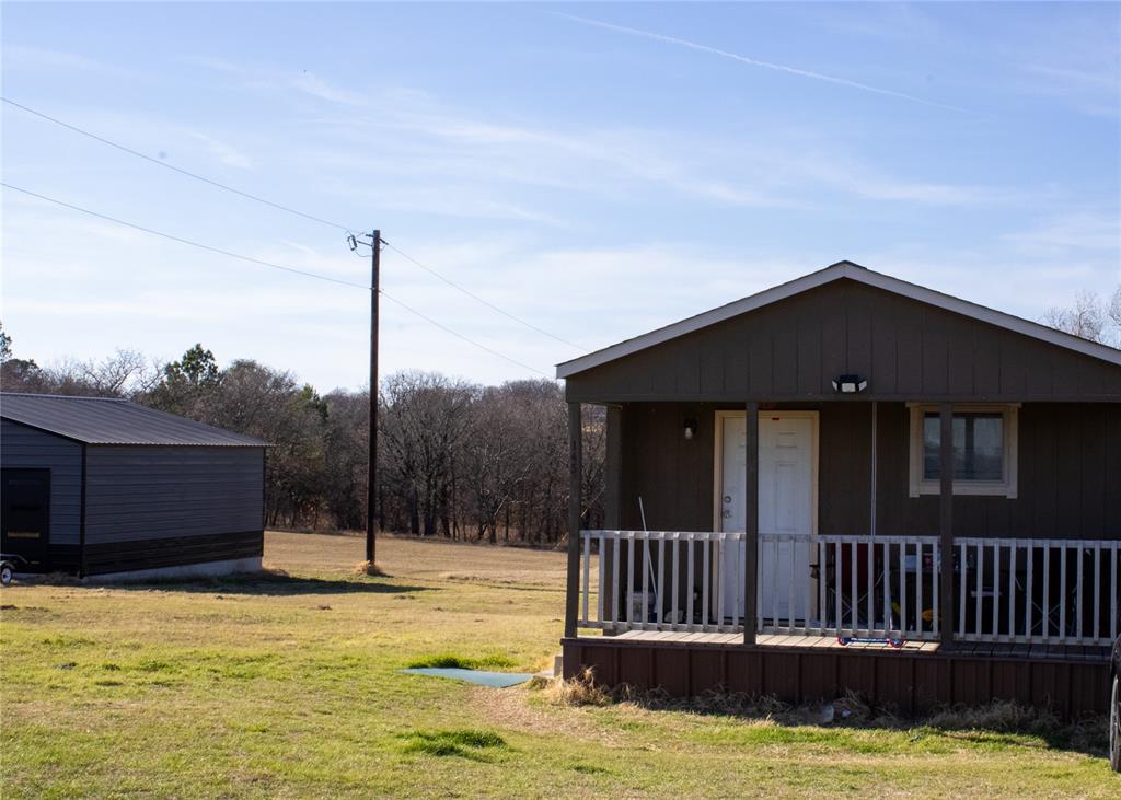 145 Firefly Drive Springtown, TX 76082 - Photo 5 of 16 a view of a house with a wooden fence