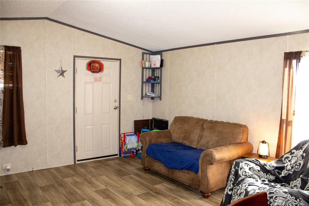 145 Firefly Drive Springtown, TX 76082 - Photo 7 of 16 a living room with furniture and a window