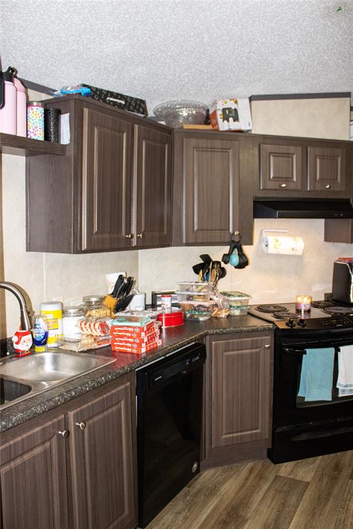 145 Firefly Drive Springtown, TX 76082 - Photo 8 of 16 a kitchen with stainless steel appliances granite countertop a sink stove and cabinets