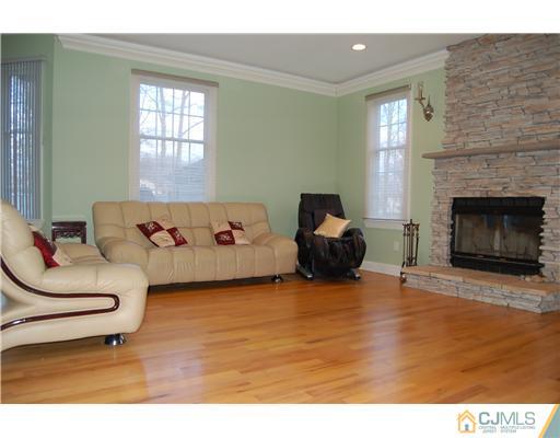 12 Ramsey Road Edison, NJ 08820 - Photo 11 of 25 a living room with furniture and a fireplace