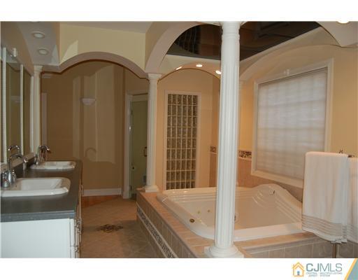 12 Ramsey Road Edison, NJ 08820 - Photo 12 of 25 a bathroom with a tub sink and mirror