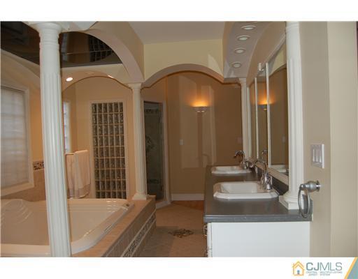 12 Ramsey Road Edison, NJ 08820 - Photo 13 of 25 a bathroom with a sink and a mirror
