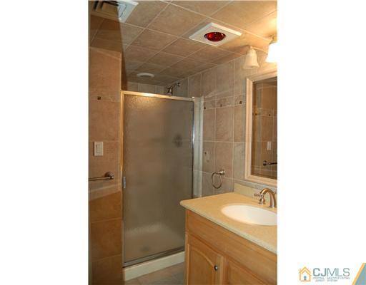 12 Ramsey Road Edison, NJ 08820 - Photo 15 of 25 a bathroom with a sink and a mirror