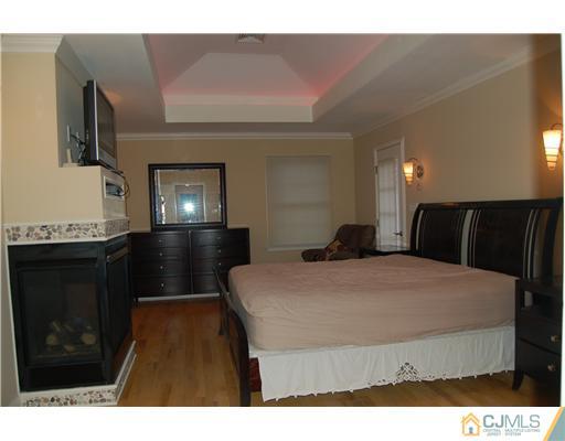 12 Ramsey Road Edison, NJ 08820 - Photo 17 of 25 a living room with furniture and a fireplace