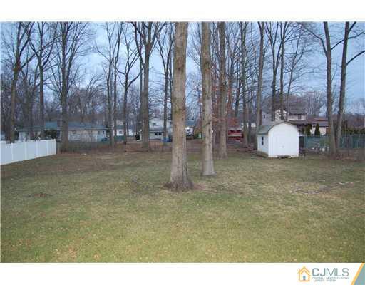 12 Ramsey Road Edison, NJ 08820 - Photo 22 of 25 a backyard of apartments with large trees
