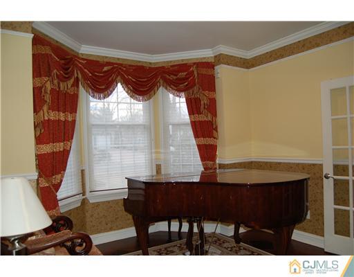 12 Ramsey Road Edison, NJ 08820 - Photo 4 of 25 a bedroom with a bed and a table in it