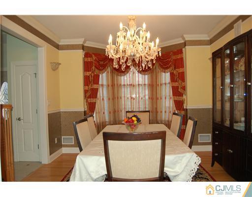12 Ramsey Road Edison, NJ 08820 - Photo 5 of 25 a living room with furniture and a chandelier