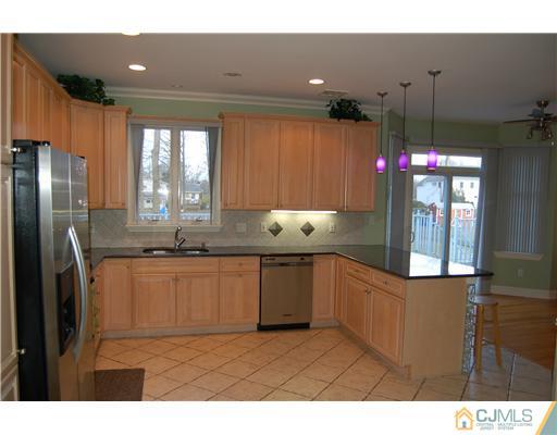 12 Ramsey Road Edison, NJ 08820 - Photo 8 of 25 a kitchen with stainless steel appliances granite countertop a stove a sink and a refrigerator
