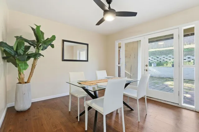 a spacious bedroom with a bed and a potted plant