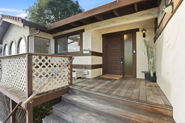a view of a house with wooden fence