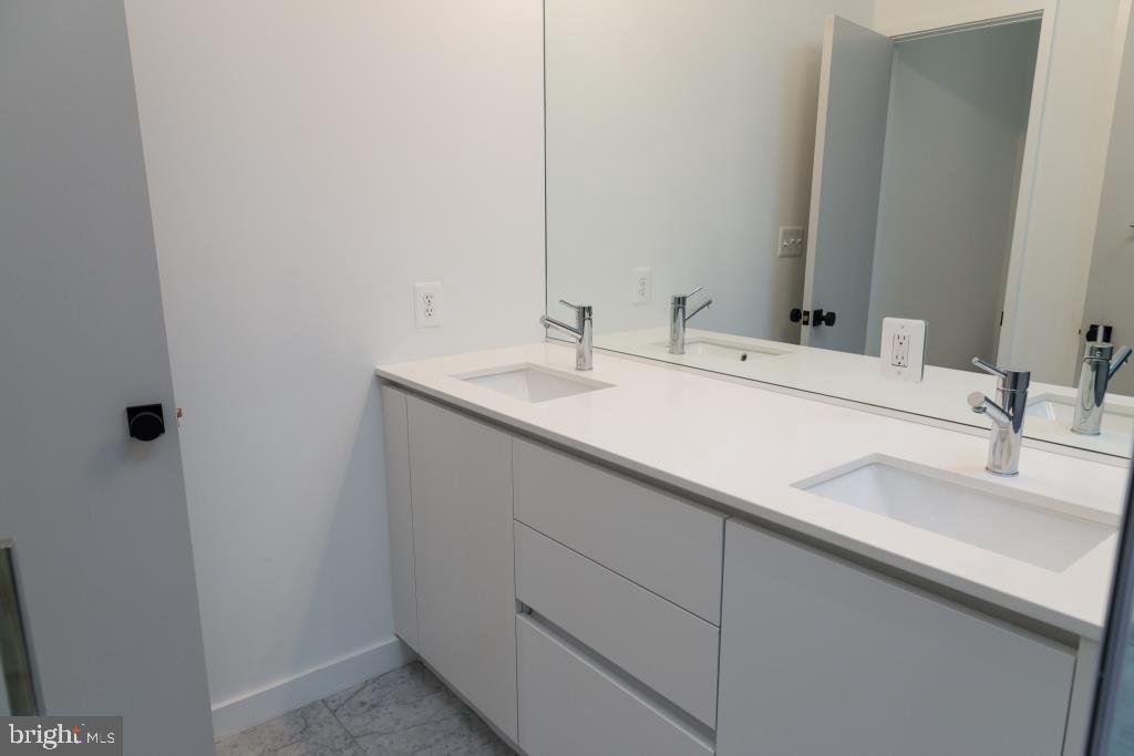 1443 Euclid Street Northwest, Unit 8 Washington, DC 20009 - Photo 17 of 20 a bathroom with a sink and a mirror