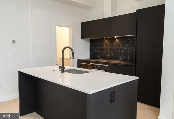 a kitchen with a sink and a stove