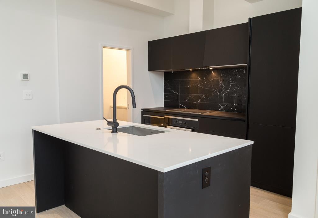 1443 Euclid Street Northwest, Unit 8 Washington, DC 20009 - Photo 3 of 20 a kitchen with a sink and a stove