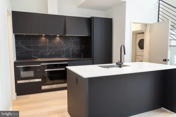 a kitchen with a sink and stainless steel appliances
