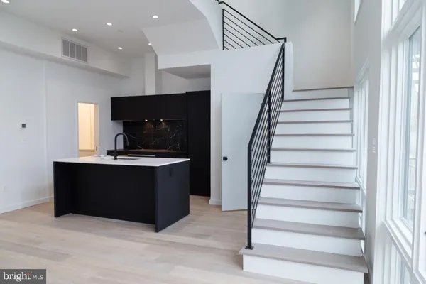 a view of kitchen with microwave and cabinets