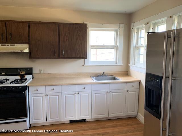 1428 6th Avenue Neptune, NJ 07753 - Photo 3 of 6 a kitchen with stainless steel appliances granite countertop a refrigerator and a sink