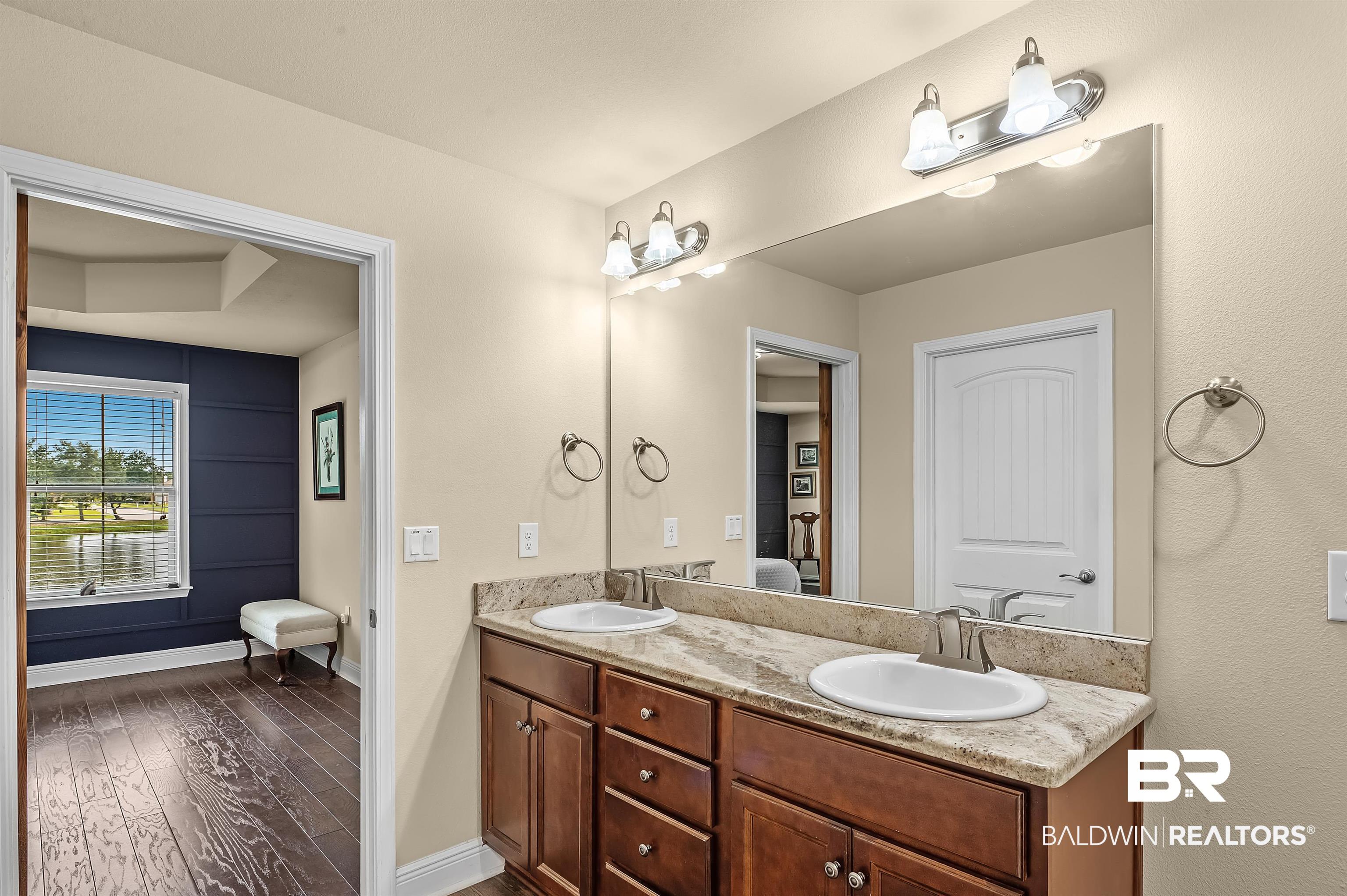 8896 Allay Lane Foley, AL 36535 - Photo 48 of 57 Bathroom with vanity and hardwood / wood-style floors