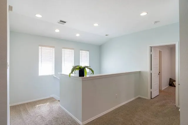 an empty room with windows and cabinet