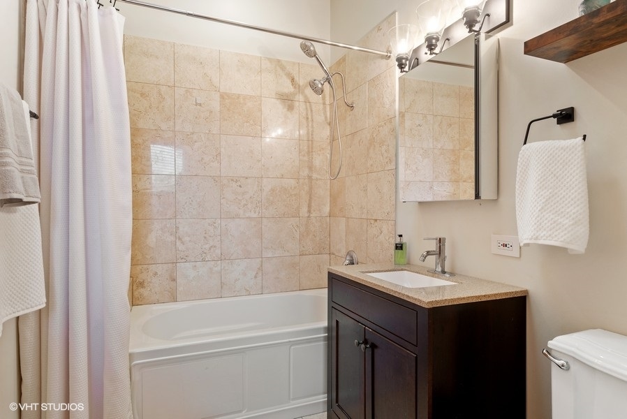4070 North Sheridan Road, Unit 3 Chicago, IL 60613 - Photo 19 of 21 a bathroom with a sink and a mirror