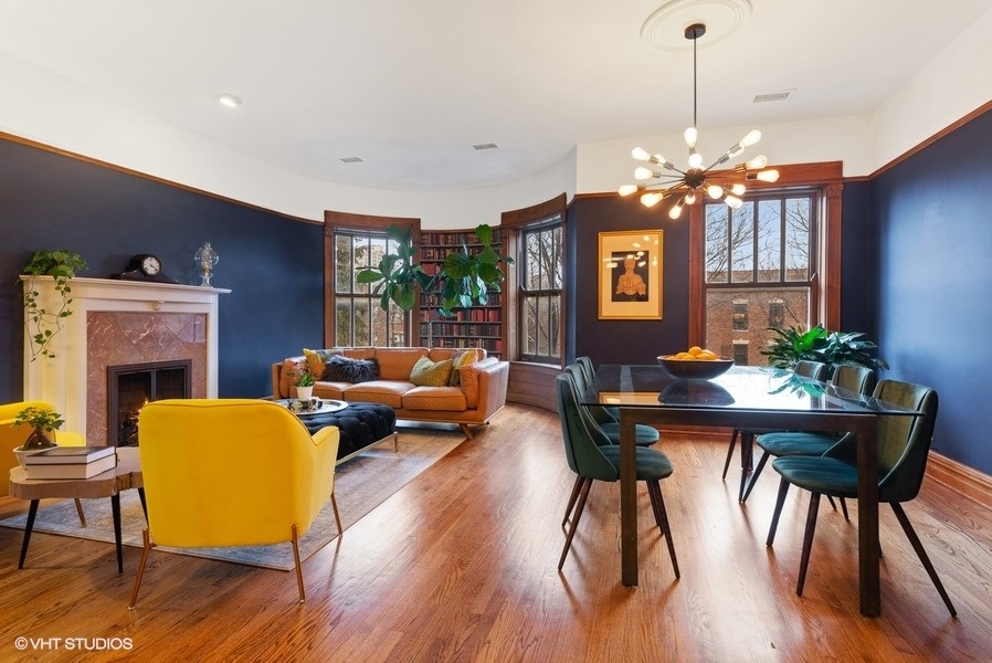 4070 North Sheridan Road, Unit 3 Chicago, IL 60613 - Photo 7 of 21 a living room with furniture a chandelier and a fireplace