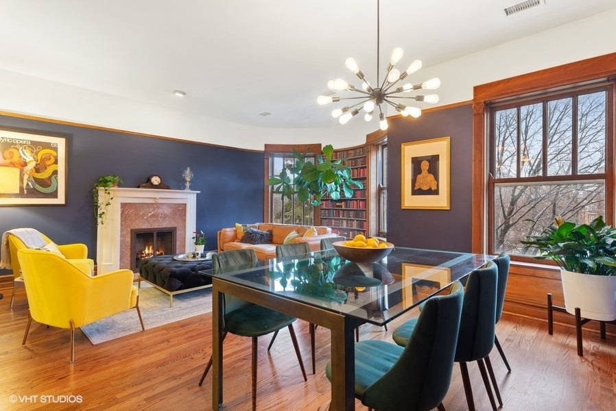 4070 North Sheridan Road, Unit 3 Chicago, IL 60613 - Photo 8 of 21 a view of a dining room with furniture a chandelier and wooden floor
