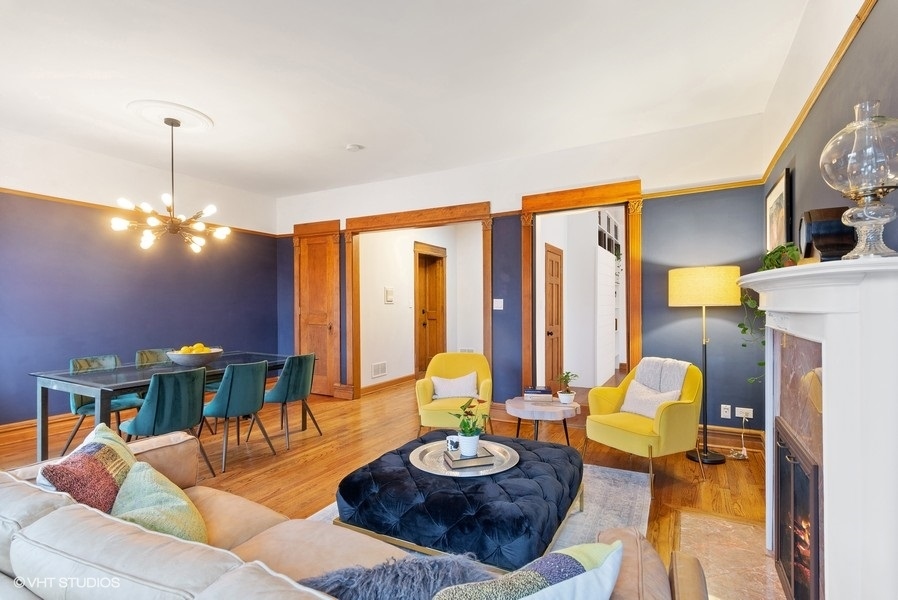 4070 North Sheridan Road, Unit 3 Chicago, IL 60613 - Photo 9 of 21 a living room with furniture and a chandelier