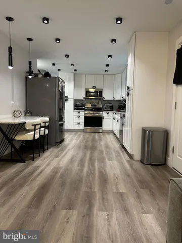 a kitchen with furniture and a refrigerator