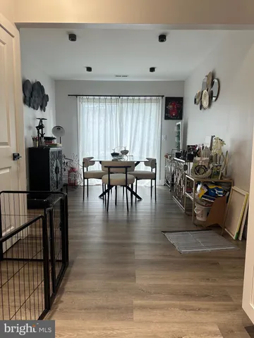 a dining room with furniture window and wooden floor