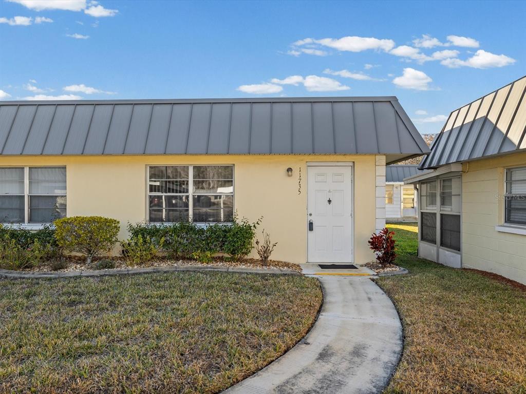 11735 Boynton Lane, Unit 11735 New Port Richey, FL 34654 - Photo 1 of 25 a house view with a backyard space