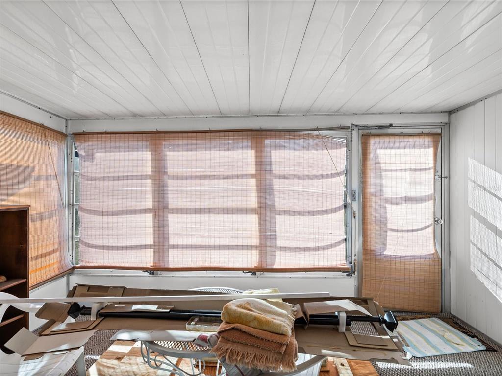 11735 Boynton Lane, Unit 11735 New Port Richey, FL 34654 - Photo 18 of 25 a room with furniture and large windows