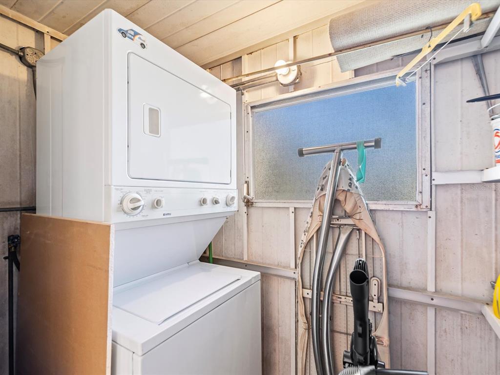 11735 Boynton Lane, Unit 11735 New Port Richey, FL 34654 - Photo 20 of 25 a view of storage and utility room with washer and dryer