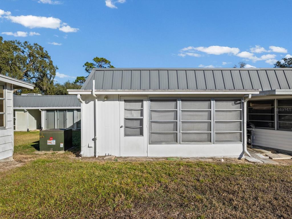 11735 Boynton Lane, Unit 11735 New Port Richey, FL 34654 - Photo 21 of 25 a view of a house with wooden fence
