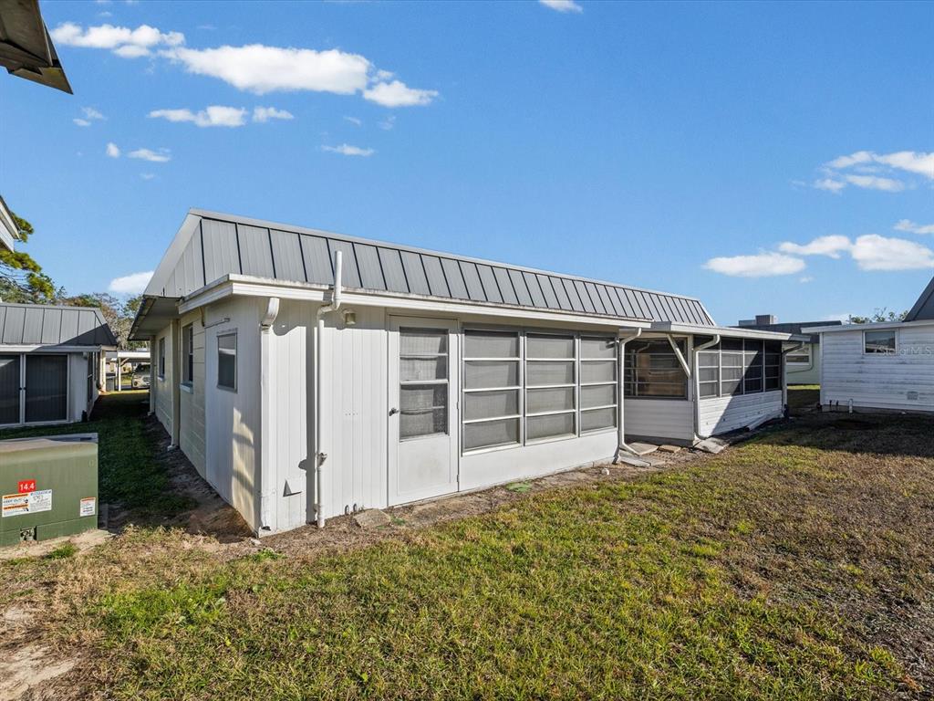 11735 Boynton Lane, Unit 11735 New Port Richey, FL 34654 - Photo 23 of 25 a view of a house with a backyard