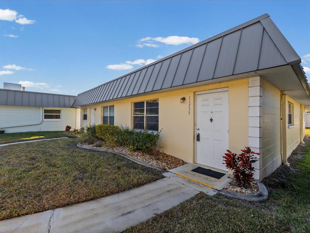 11735 Boynton Lane, Unit 11735 New Port Richey, FL 34654 - Photo 24 of 25 a front view of house with yard